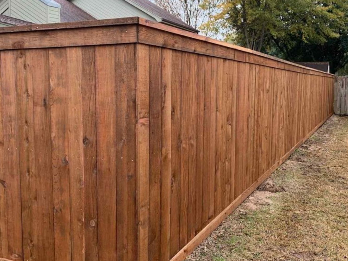 Lewisville AK cap and trim style wood fence